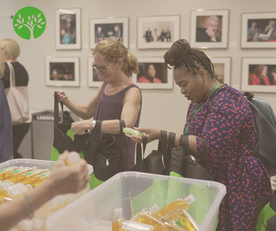 Volunteers at the Dignity Grows Summit on Period Poverty in 2023 move down an assembly line filling Tote bags with supplies